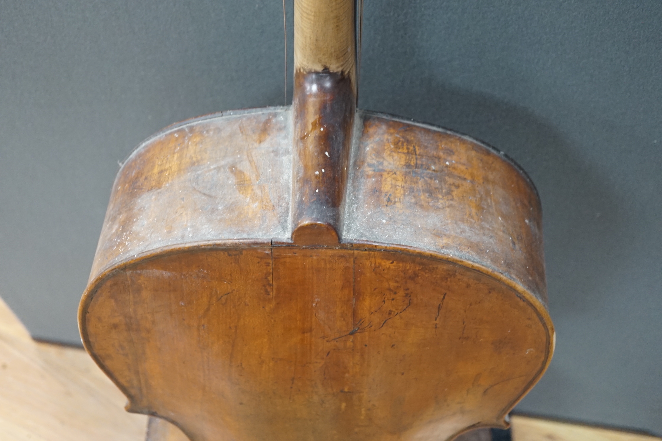 An early 20th century cello for restoration, indistinct internal label; ‘Restored by William J. Acton, Green Street, Forest Gate, London 1910’ length of body 72cm.